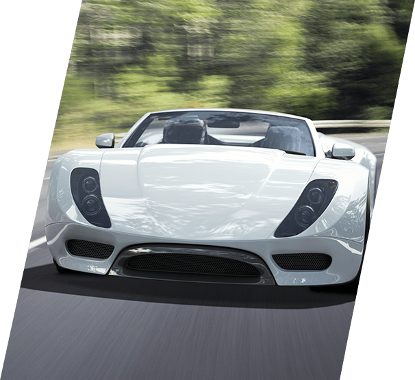 White sports car travelling fast on a winding forest road