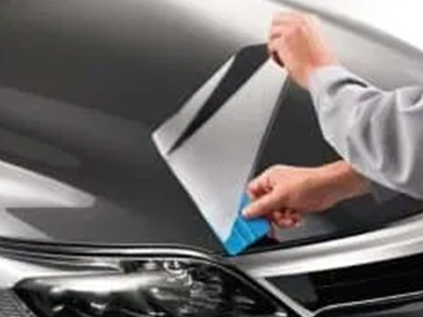 Man removing wrap from car