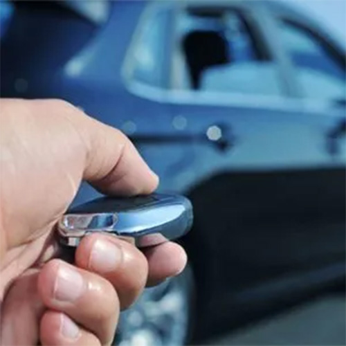 Person locking and unlocking car using keys