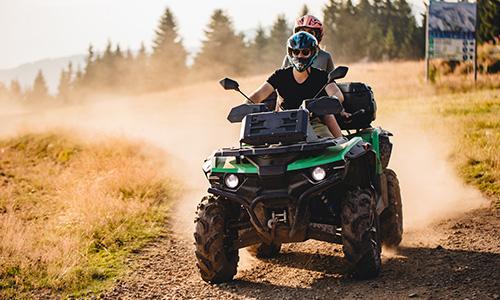 Extreme sports couple riding on a quad bike together